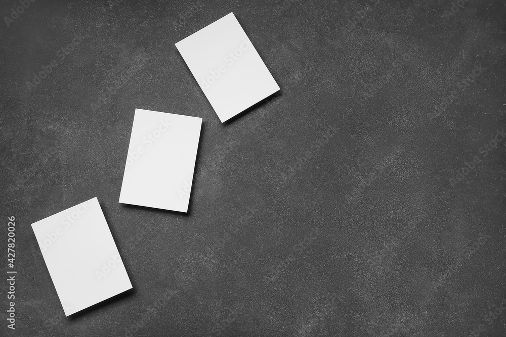Blank sheets of paper on dark background Blank sheets of paper on dark background