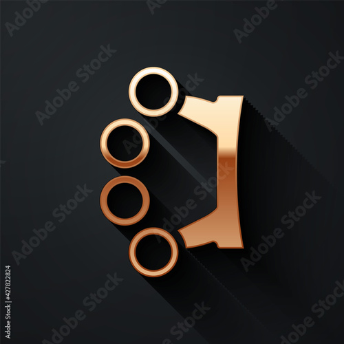 Gold Brass knuckles icon isolated on black background. Long shadow style. Vector