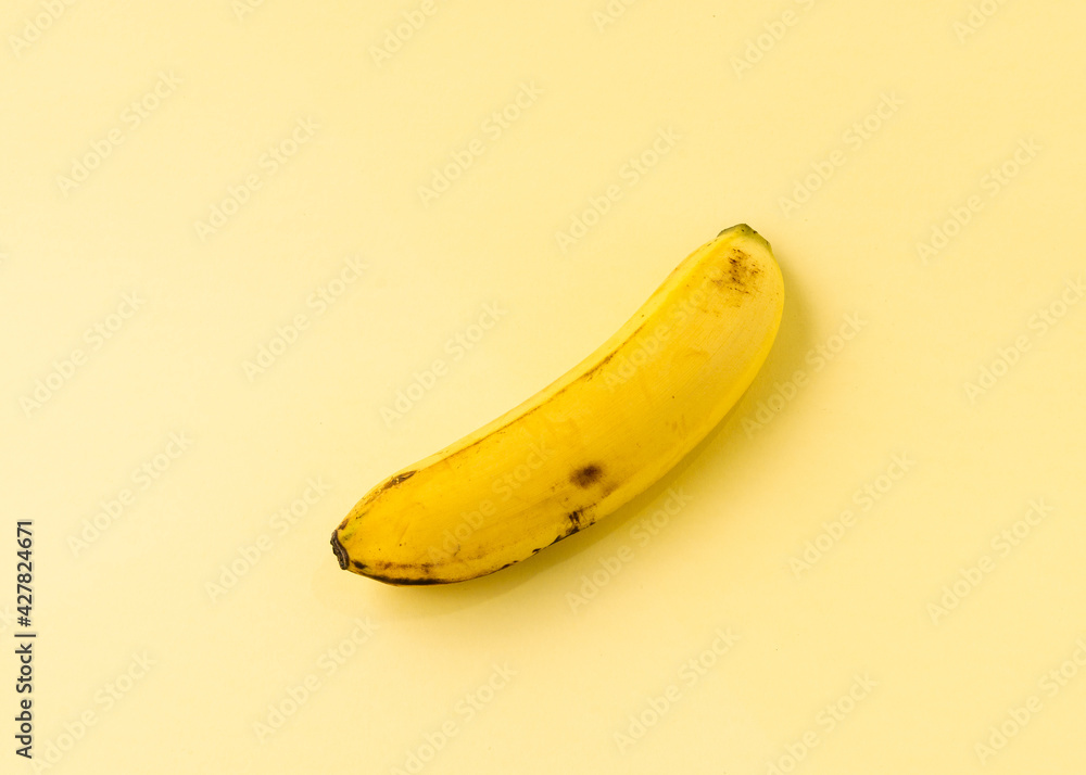 A banana on a yellow background. A banana on a yellow background.