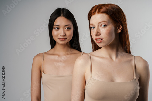 Close up studio portrait of two beautiful young girls