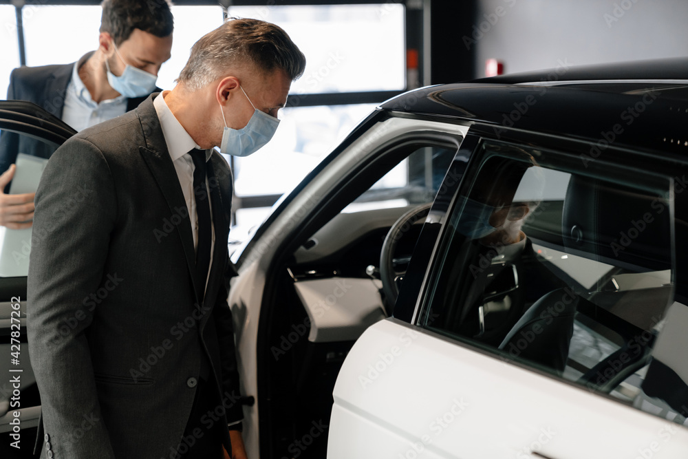 Salesman and customer in a car dealership