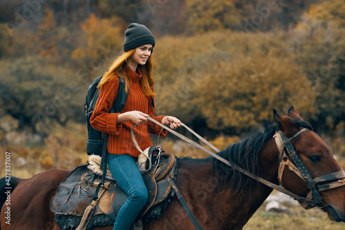 woman tourist riding horse mountains landscape lifestyle