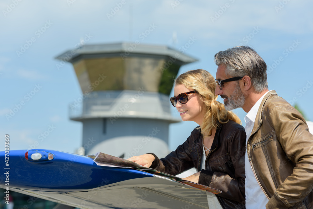 man and a woman looking at maps outdoors