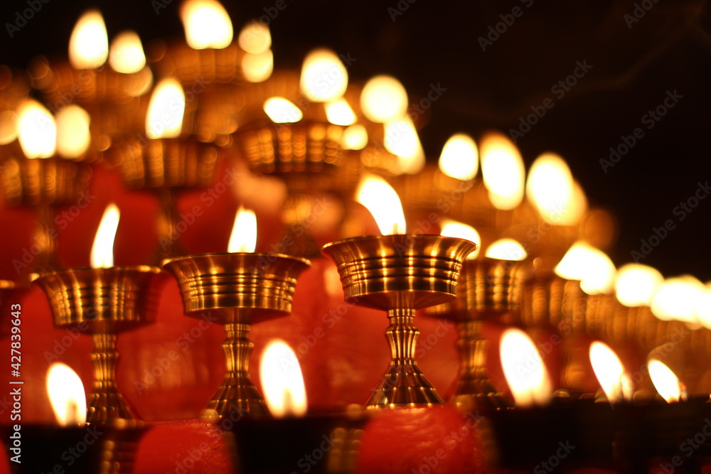 Buddhist Altar Candles at Religious 108 Butter Lamp Festival in Temple Monastery. Beautiful Tranquil Scenic View of Oil Lamps and Swaying Flame for Praying Buddhist Altar Candles at Religious 108 Butter Lamp Festival in Temple Monastery. Beautiful Tranquil Scenic View of Oil Lamps and Swaying Flame for Praying