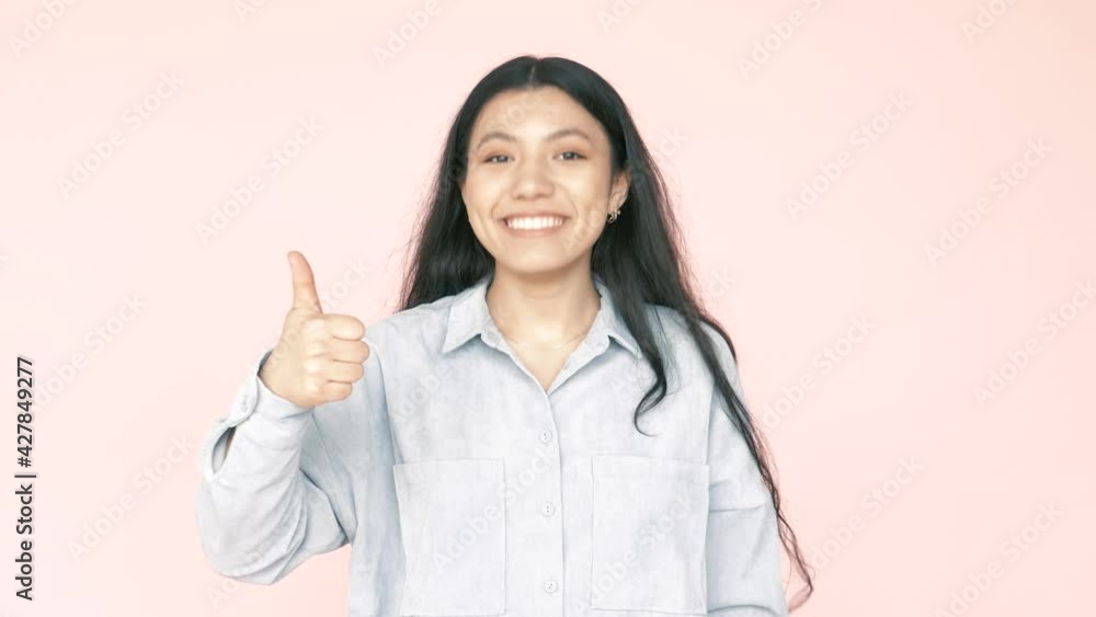 Overjoyed positive woman pointing fingers at herself and showing thumb up, looking at camera with smile, cheerful satisfied with her achievements. Indoor studio shot isolated on pink background Overjoyed positive woman pointing fingers at herself and showing thumb up, looking at camera with smile, cheerful satisfied with her achievements. Indoor studio shot isolated on pink background