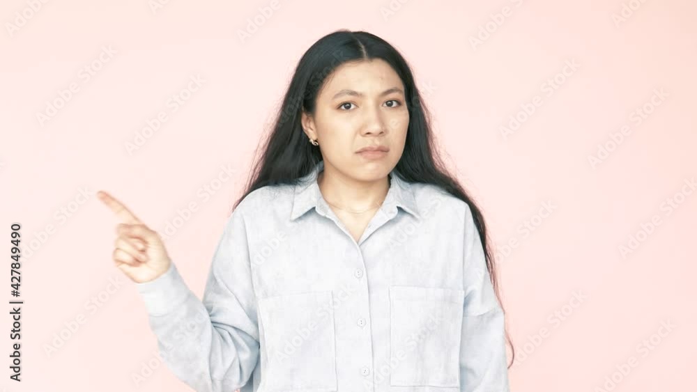 No no no! Young adult brunette woman pointing on herself, warning with finger, saying no, be careful, scolding and giving advice to avoid danger. Indoor studio shot isolated on pink background. No no no! Young adult brunette woman pointing on herself, warning with finger, saying no, be careful, scolding and giving advice to avoid danger. Indoor studio shot isolated on pink background.