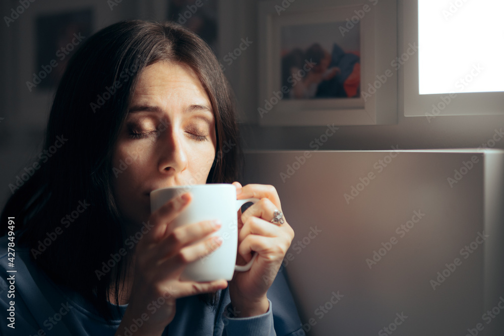 Woman Drinking Tea for Insomnia Sitting in her Bedroom Woman Drinking Tea for Insomnia Sitting in her Bedroom