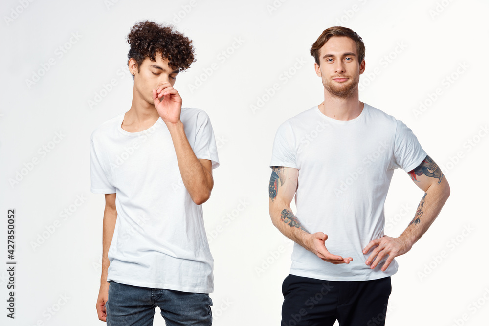 two men in white t-shirts stand side by side cropped view studio two men in white t-shirts stand side by side cropped view studio