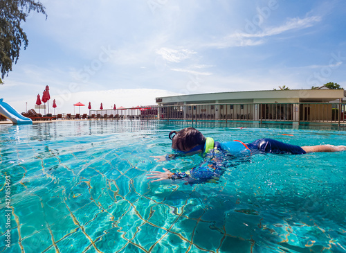 Happy young boy swim