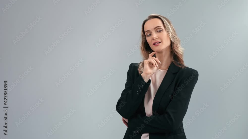 Portrait smiling successful female boss in suit posing isolated. Shot on RED Raven 4k Cinema Camera Portrait smiling successful female boss in suit posing isolated. Shot on RED Raven 4k Cinema Camera