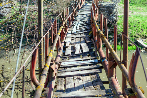 Photos Rickety bridge for pedestrian passing across the river