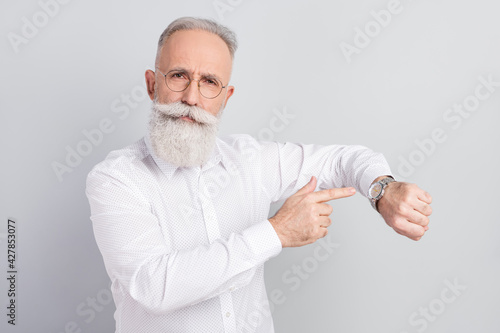 Photo of aged business man boss point finger time watch late deadline isolated over grey color background