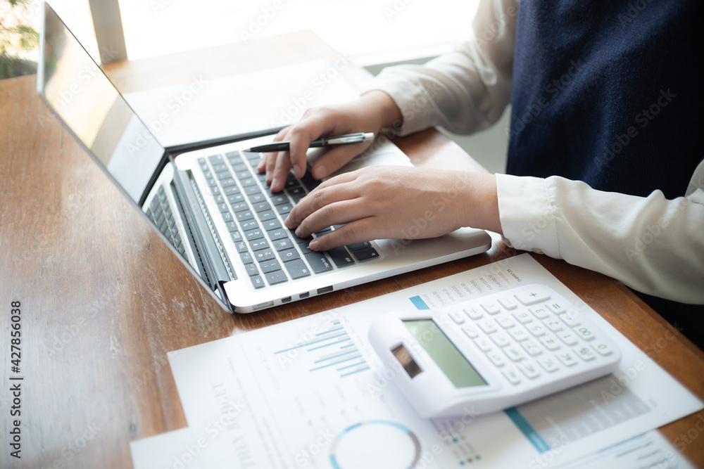 Close up of businessperson using laptop working with digital data.. Close up of businessperson using laptop working with digital data..