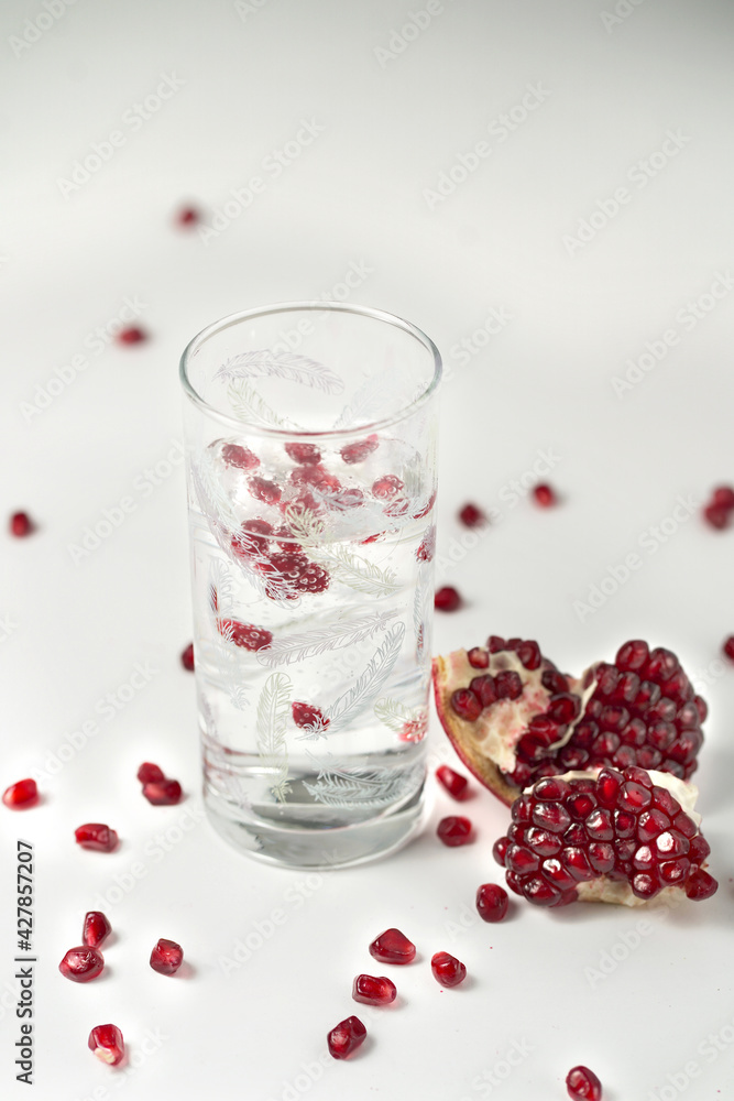glass with pomegranate and soda on a white background glass with pomegranate and soda on a white background