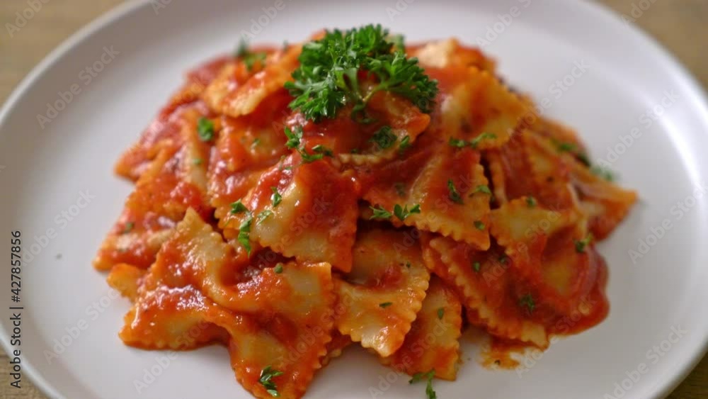 farfalle pasta in tomato sauce with parsley - Italian food style farfalle pasta in tomato sauce with parsley - Italian food style
