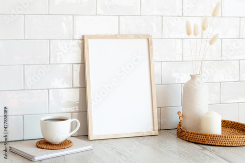 White picture frame mockup and home decor on table. Scandinavian living room interior design. Nordic style.