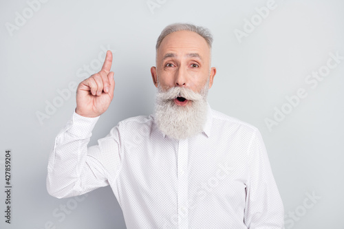 Photo of aged man happy positive smile point finger genius idea plan decision isolated over grey color background