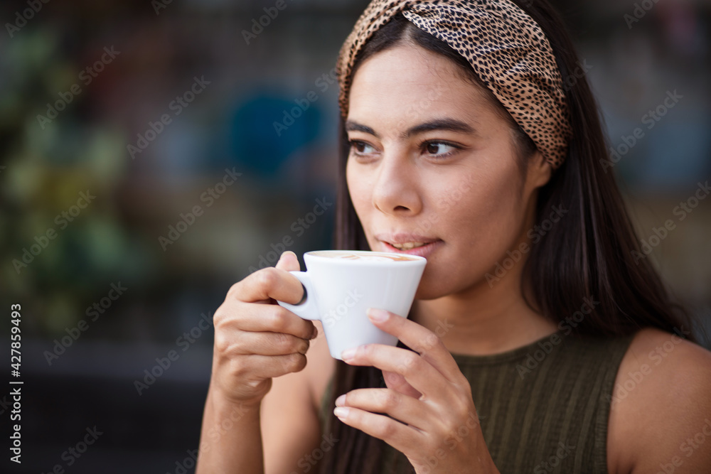 African woman holding and drinking coffee alone. African woman holding and drinking coffee alone.