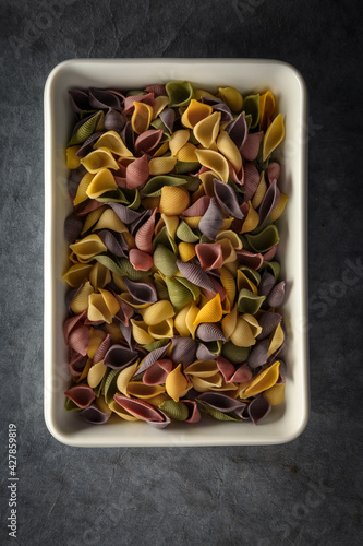 Dark Food Photography Pasta on white dish, dark background, text space.