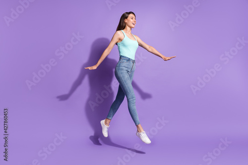 Full size profile side photo of walk jump up air empty space happy sale summer mood isolated on violet color background
