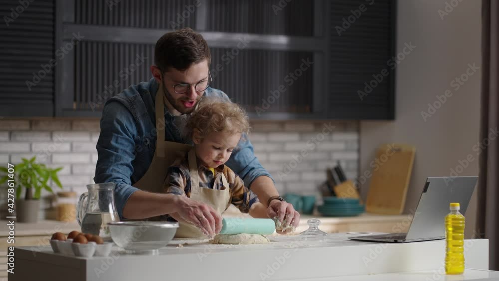 father and son at kitchen, cooking, rolling out a dough, spending time together at weekends, medium portrait father and son at kitchen, cooking, rolling out a dough, spending time together at weekends, medium portrait