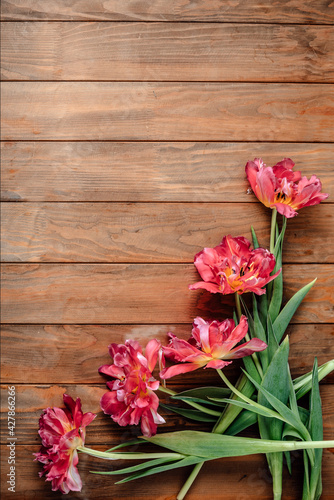 Bouquet of beautiful tulips on a wooden table.