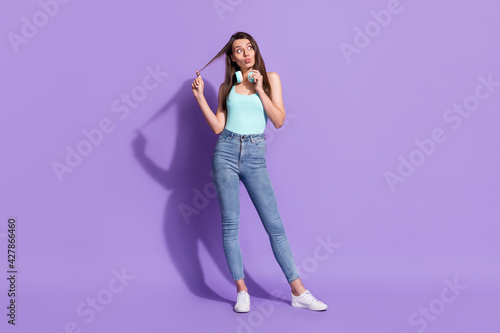 Full length photo of look empty space wear headphones pouted lips shock isolated on purple color background