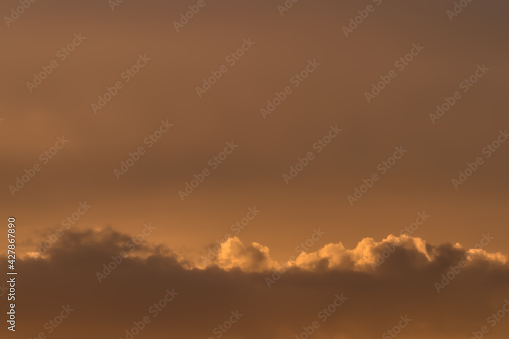 Beautiful evening sky with warm cocoa color clouds. Natural abstract background.