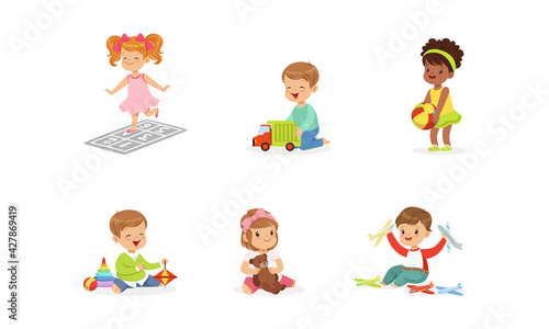 Happy Cute Kids Playing Toys Set  Little Boys and Girls Hugging Teddy Bear  Playing with Ball  Car  Pyramid Cartoon Vector Illustration