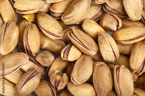 Pistachios. Pistachios on a white background. California pistachios. Pistachio texture. Macro photography of pistachios.