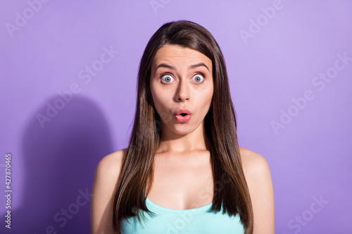 Photo of astonished amazed young pretty woman impressed discount isolated on purple color background