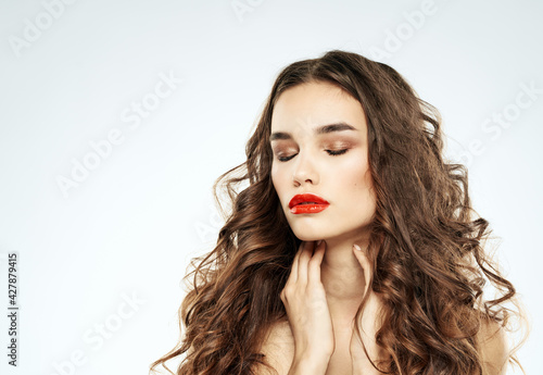 Beautiful woman red lips with eyeshadow and curly hair