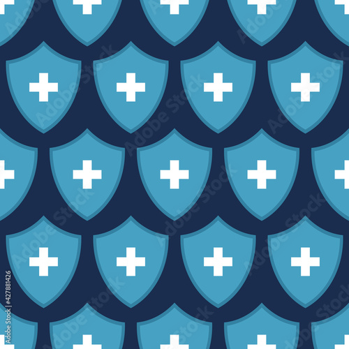 Seamless vector pattern of blue shields with white crosses, isolated on dark background. Health protection concept. Shield icon for health, medica. Flat design. Color Illustration.