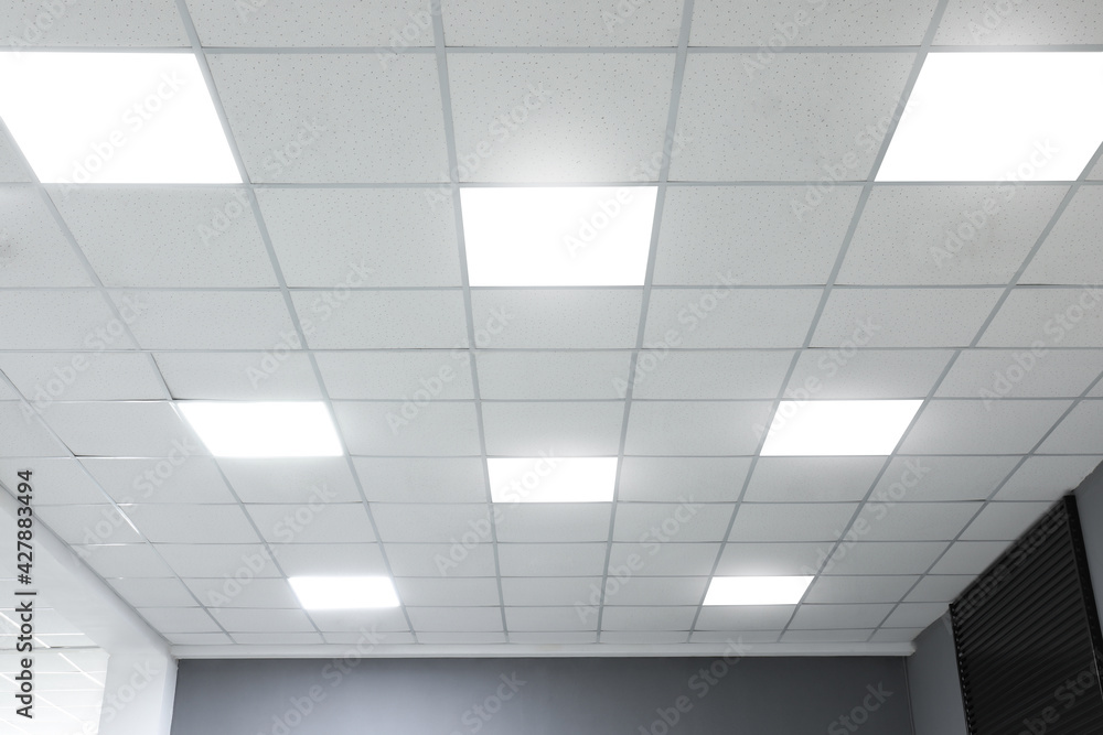 White ceiling with lighting in office room - obrazy, fototapety, plakaty 