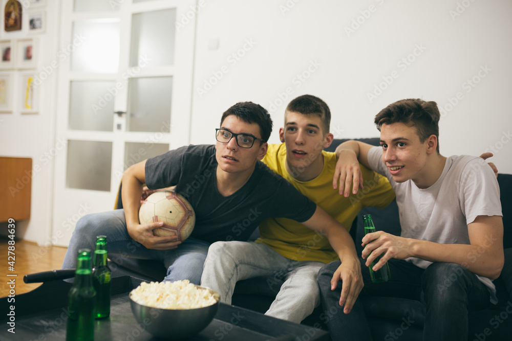 friends looking soccer on tv at home friends looking soccer on tv at home