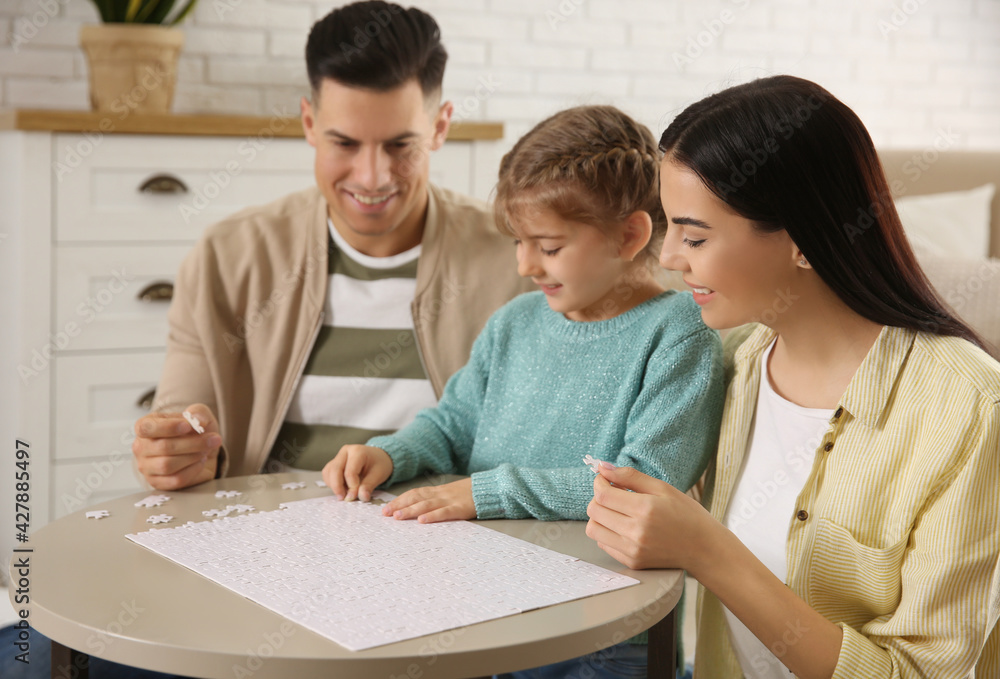 Happy family playing with puzzles at home Happy family playing with puzzles at home