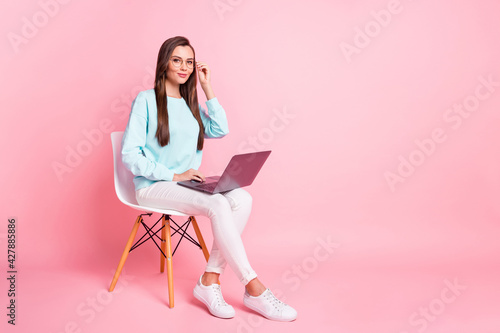 Full body portrait of pretty positive person arm touch eyewear use laptop isolated on pink color background