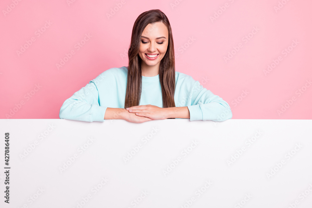 Portrait of attractive person look empty space banner down wear sweater isolated on pink color background Portrait of attractive person look empty space banner down wear sweater isolated on pink color background