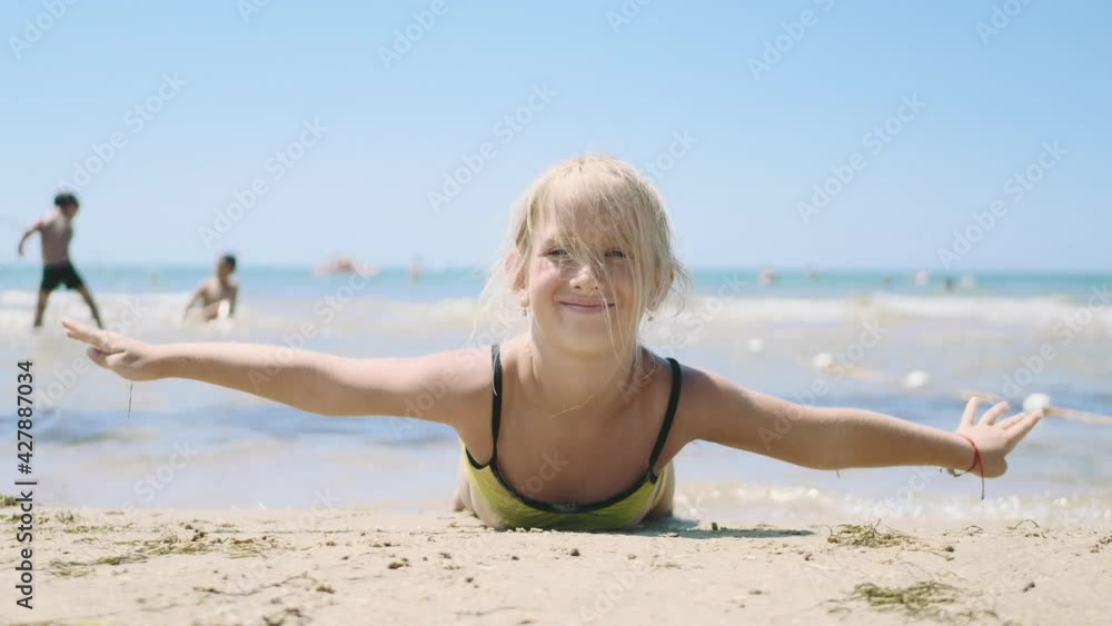 Little girl play on the plane. Child having fun on the beach against sea and sky background. Happy family on the beach. Girl having fun on summer vacation. Summer vacation and travel concept. Little girl play on the plane. Child having fun on the beach against sea and sky background. Happy family on the beach. Girl having fun on summer vacation. Summer vacation and travel concept.