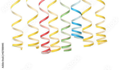 Colorful serpentine streamers on white background. Festive decor