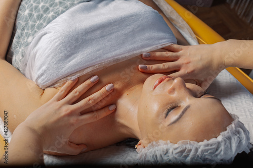 Professional beautician woman massaging the client s neck.