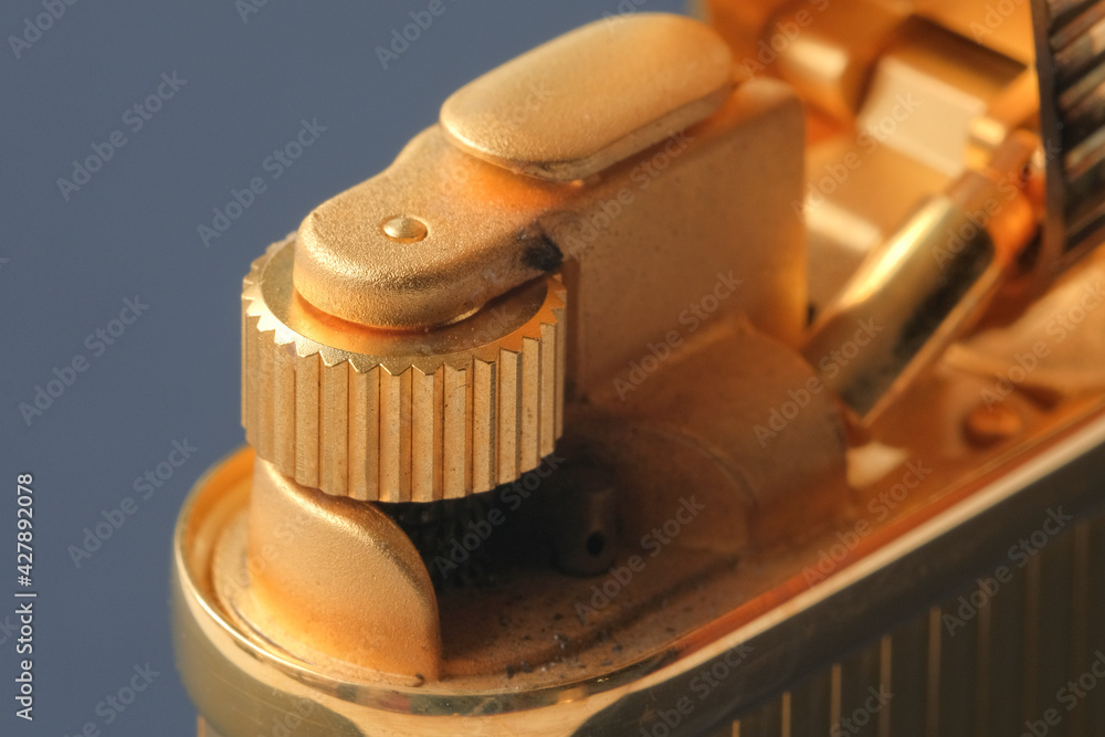 Macro shot of a lighter, parts devices, wheels for extracting sparks and holes in places of fire. Close-up. View from above. High quality photo Macro shot of a lighter, parts devices, wheels for extracting sparks and holes in places of fire. Close-up. View from above. High quality photo