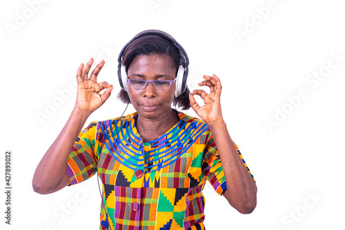 adult woman listening to music with her headphones and making okay gesture. © vystekimages