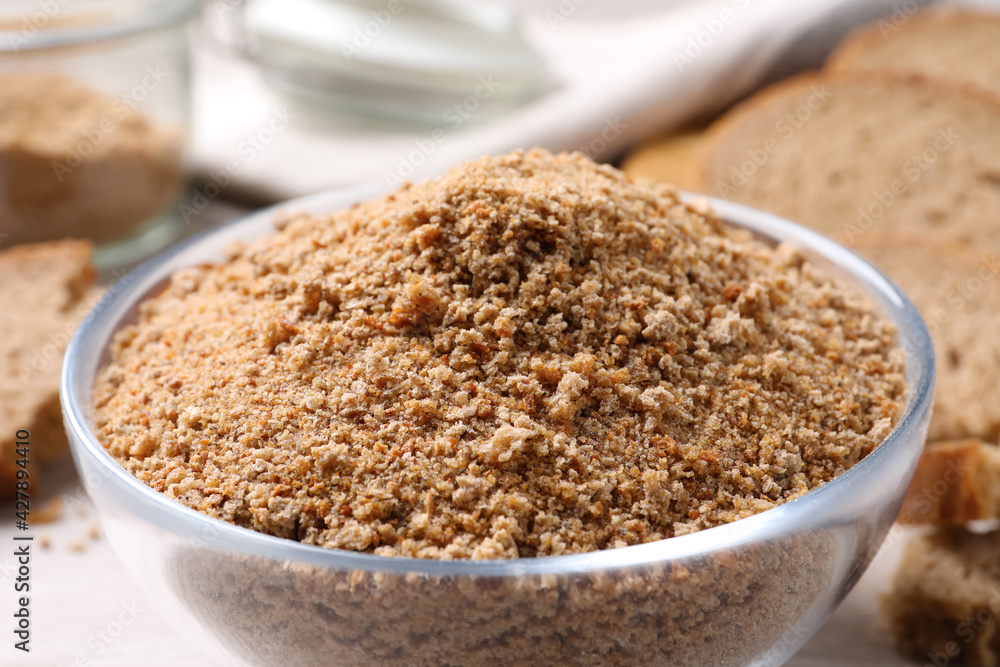 Fresh breadcrumbs in bowl on table, closeup Fresh breadcrumbs in bowl on table, closeup