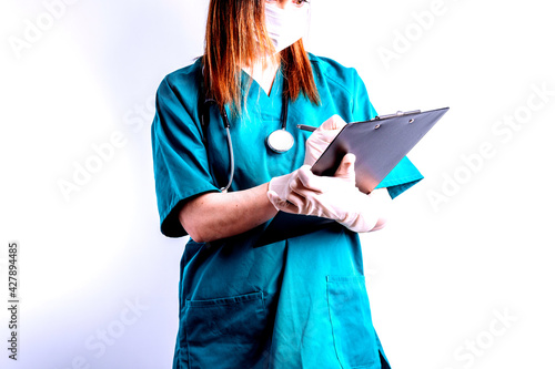 young beautiful woman with stethoscope gloves writing a report by hand. concept report for surgery.