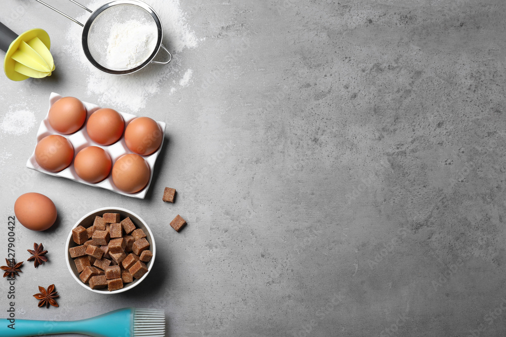 Cooking utensils and ingredients on grey table, flat lay. Space for text Cooking utensils and ingredients on grey table, flat lay. Space for text