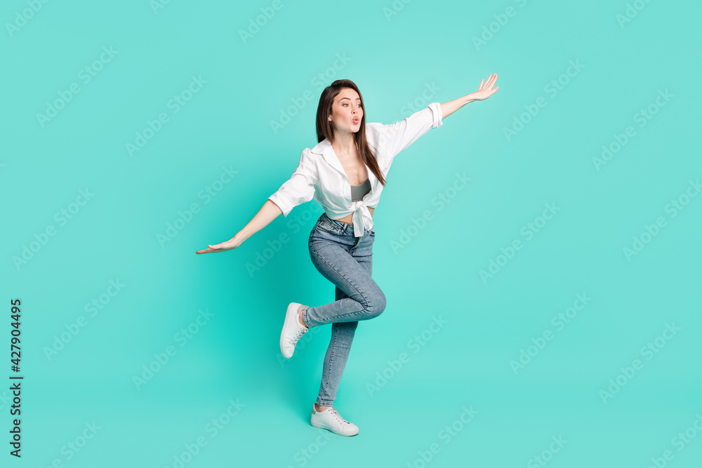 Full length photo of funky charming young lady look empty space lips pouted make hands wings isolated on teal color background