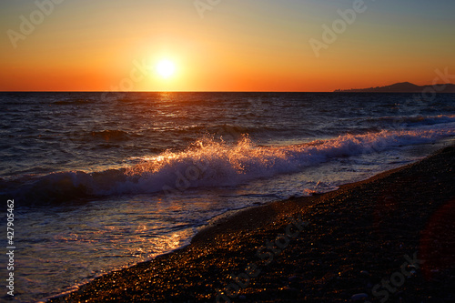 Beautiful summer orange sunset over the sea.