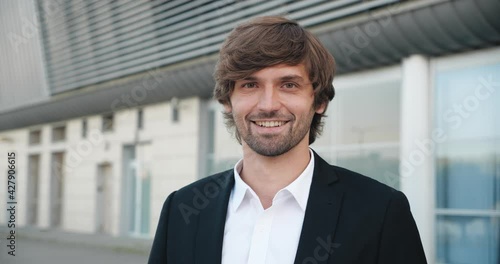 Wallpaper Mural Closeup Portrait of Young Handsome Man smiling at the Camera. Excited Confident Man showing diverse Emotions, standing outdoor, resting from busy Work. Business Portrait of Smart Male. Torontodigital.ca