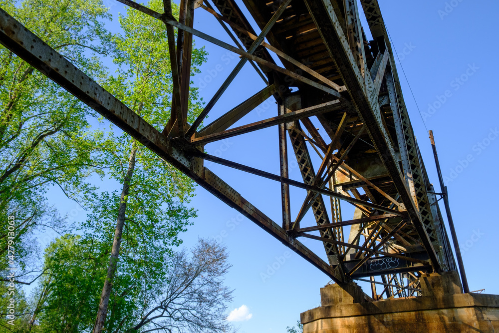 Train trestle with blue sky and treetops with negative space for copy